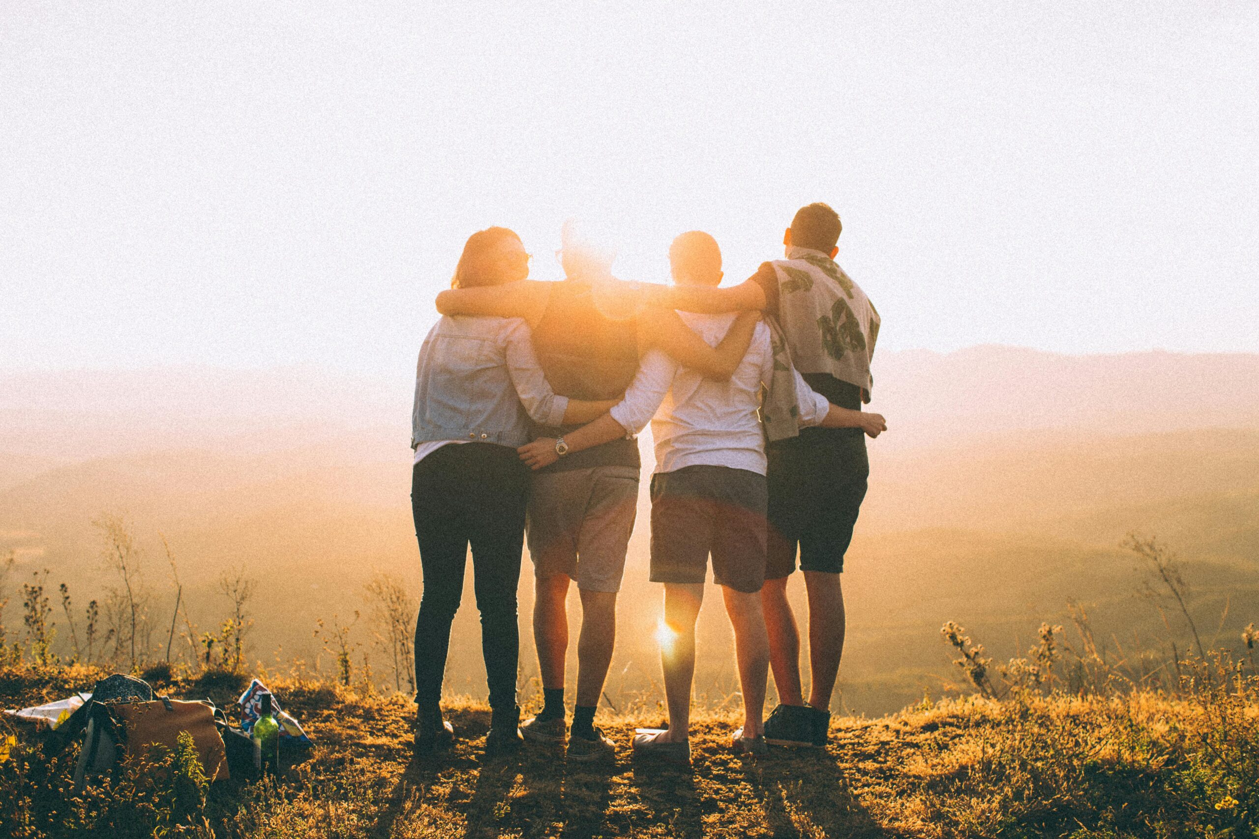 Services A group of friends embrace while enjoying a breathtaking sunrise over the Brazilian highlands.